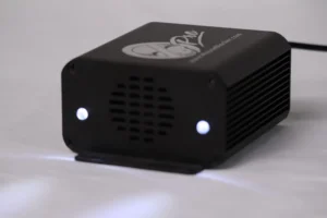 A black box with two white lights on top of it.