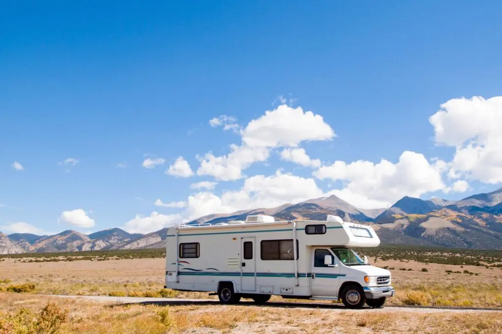 A white rv parked on the side of a road.